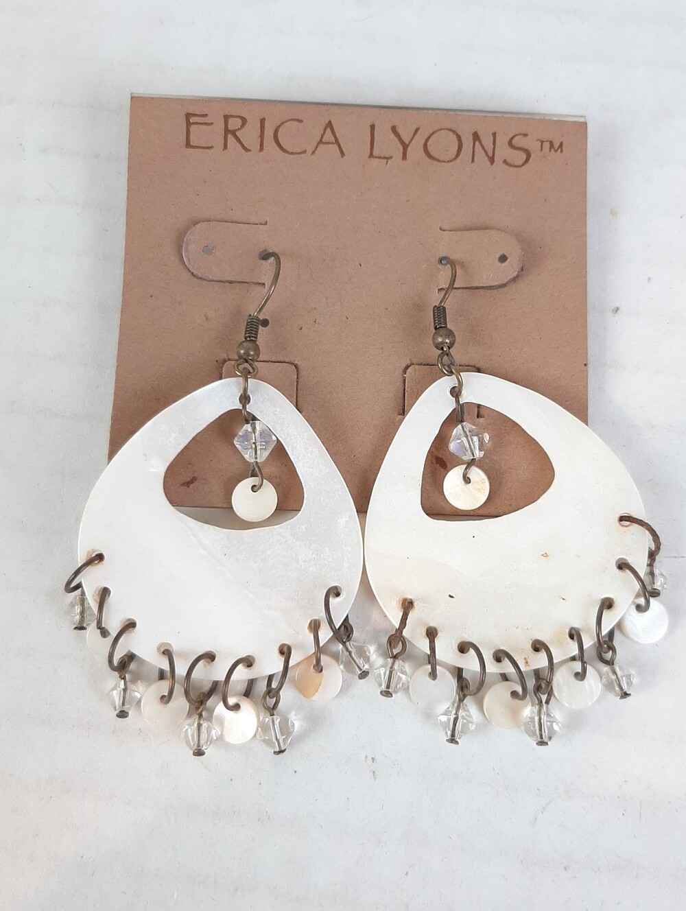 Erica Lyons dangle earrings feature teardrop white mother-of-pearl shells beaded